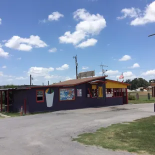 a blue building with a red roof