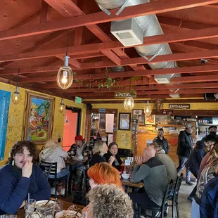 people sitting at tables in a restaurant