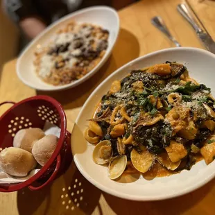 a plate of pasta and a basket of bread