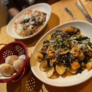 a plate of pasta with mushrooms and spinach