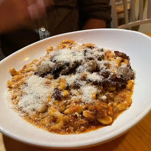 a plate of pasta with meat and cheese