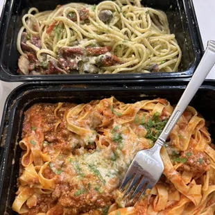 two containers of pasta and a fork