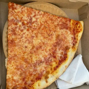 a slice of cheese pizza in a box
