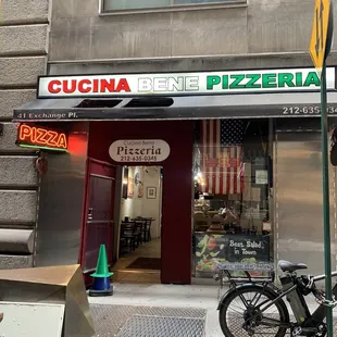 a bicycle parked in front of a pizza shop