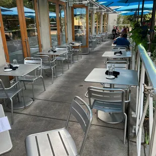 a patio with tables and chairs