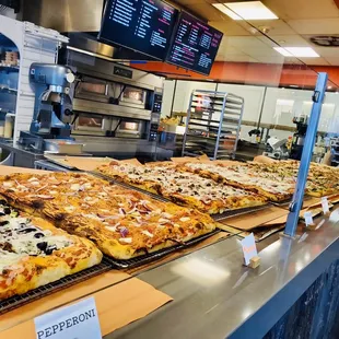 a variety of pizzas on display