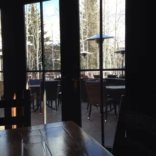 a wooden table with a glass of wine on it