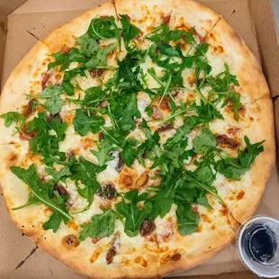 Fig and prosciutto pizza topped with arugula