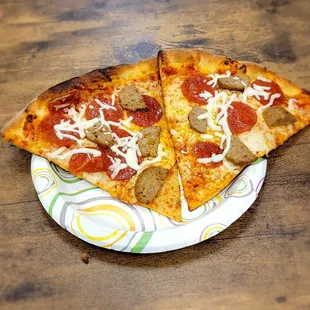 two slices of pizza on a paper plate