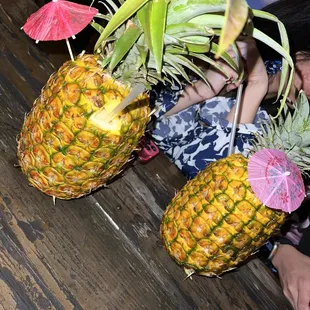 two pineapples with umbrellas