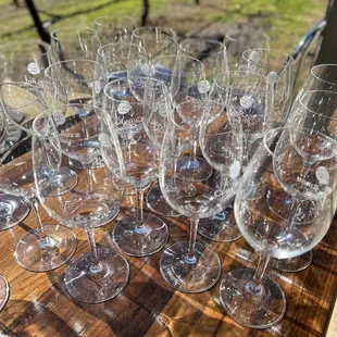 a bunch of wine glasses on a table
