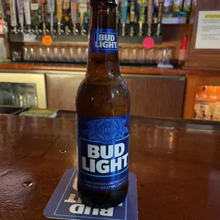 a bottle of bud light on a coaster