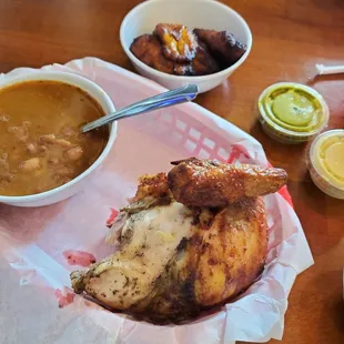 Quarter chicken comes with green and yellow sauces and 2 sides