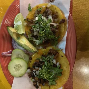 two tacos on a red plate