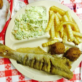 a plate of fish, fries and coleslaw