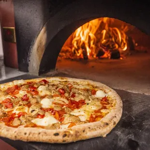 a pizza in a brick oven