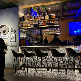 a man standing in front of a bar