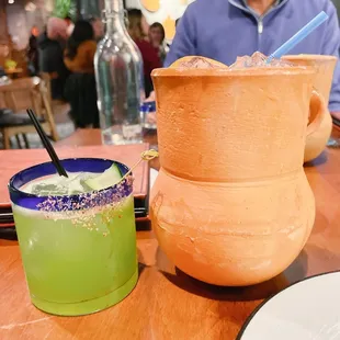 The speciality oversized cocktail next to the standard cocktail.