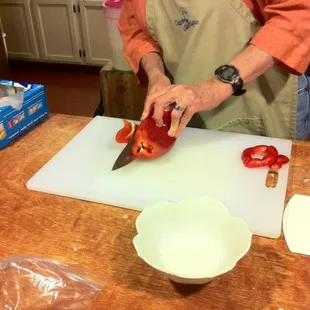 a woman chopping peppers