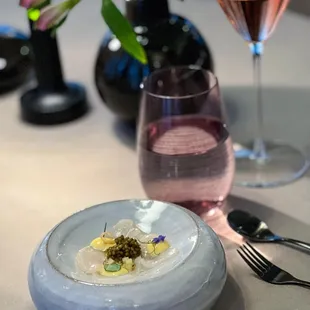 a plate of food and a glass of wine