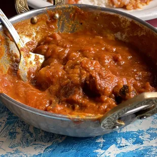 a bowl of stew and a plate of rice