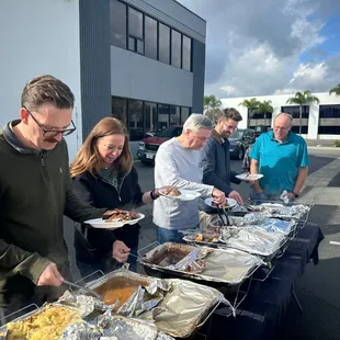 Anderson Howard team digging into Cujo's Big Smoke BBQ.