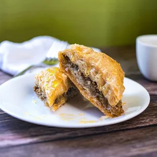 Baklava - Flaky layers of golden puff pastry separated by walnuts and sweet syrup.