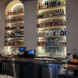 a bar with a lot of bottles on the shelves