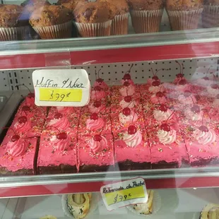 a display of cakes and muffins