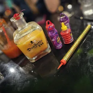 a bottle of liquid and a pencil