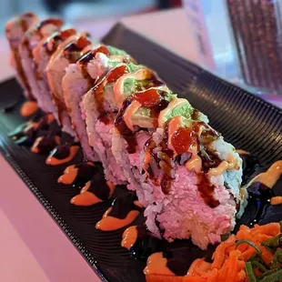 a sushi roll on a black plate