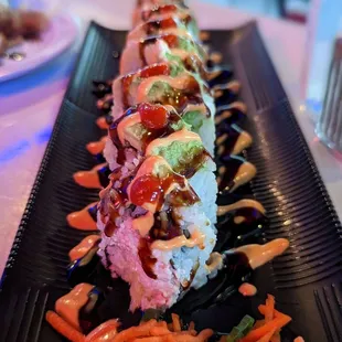 a sushi roll on a black plate