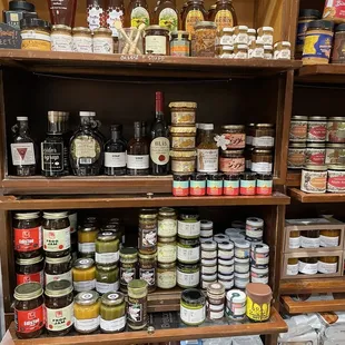 a shelf full of jars of food