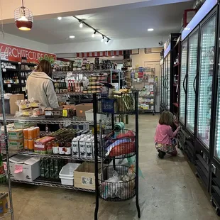 a woman and a child in a grocery store