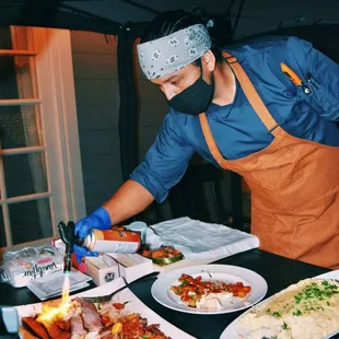 Chef Rodolfo charring tomahawk steaks