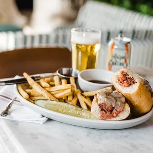 a plate of food and a glass of beer