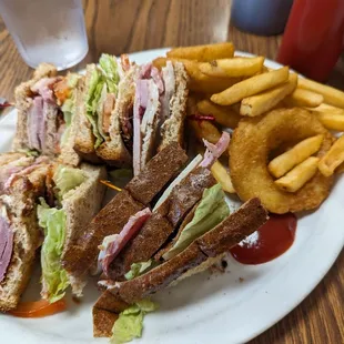 a plate of sandwiches and french fries