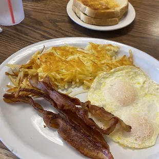 Over east eggs and bacon with sourdough .... Delicious . Perfectly cooked eggs and crispy bacon !