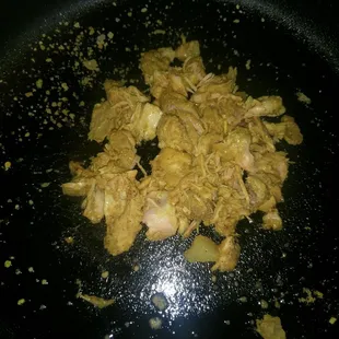 a close up of food being cooked in a pan