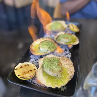 Scallops appetizer which arrived to our table on fire. Very cool