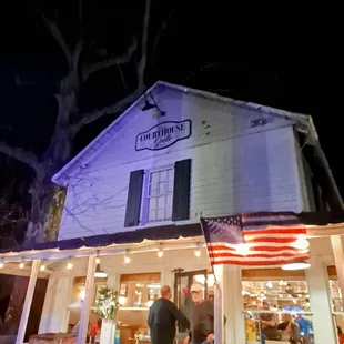 two men standing outside of a restaurant