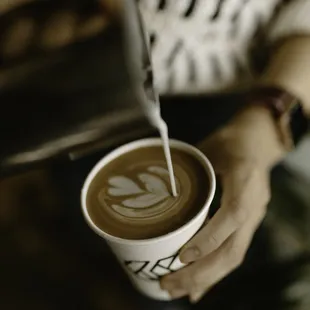 a person holding a cup of coffee