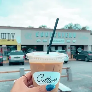 a hand holding a cup of coffee