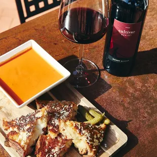 Grilled cheese and tomato soup, glass of red wine