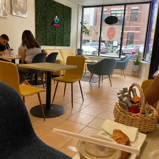 a woman sitting at a table in a coffee shop