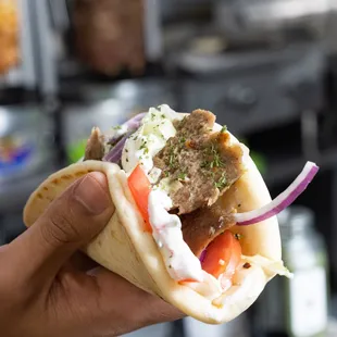 Here&apos;s our Greek Gyro Sandwich (lamb &amp; beef)  Served on a pita, topped with our delicious Tzatziki sauce, onions, tomatoes, and parsley