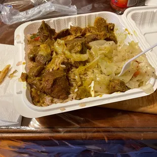 Curry goat and rice and peas and cabbage