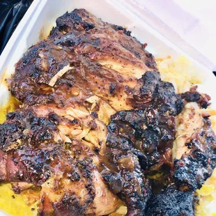 Large Jerk Chicken  on top of Rice  with Curry Sauce on it...