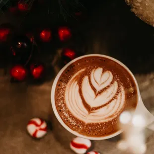 a cup of hot chocolate and candy canes