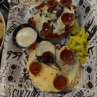 a plate of pizza with pepperoni and cheese